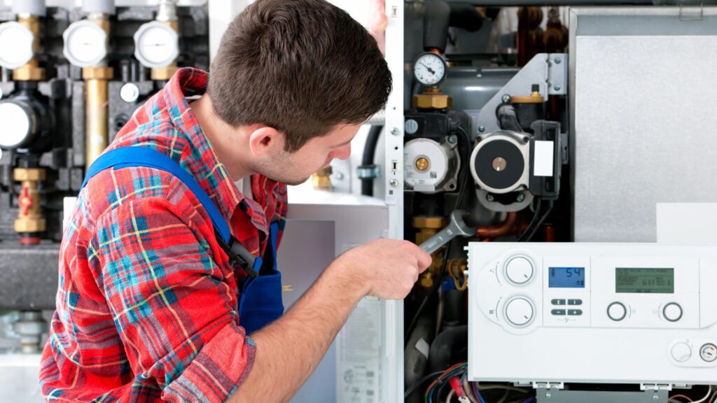 Gas engineer adjusting boiler during service in Stoke-on-Trent